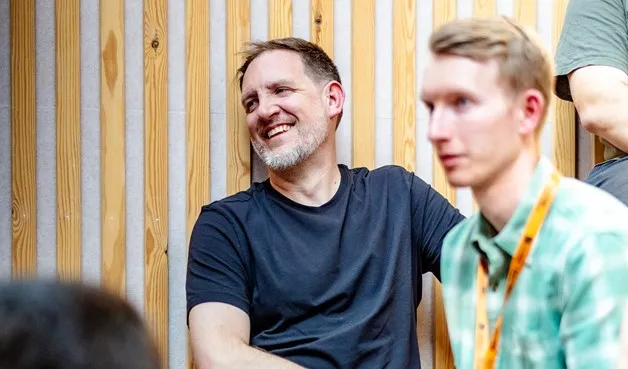 Jay and Dan listening at a talk