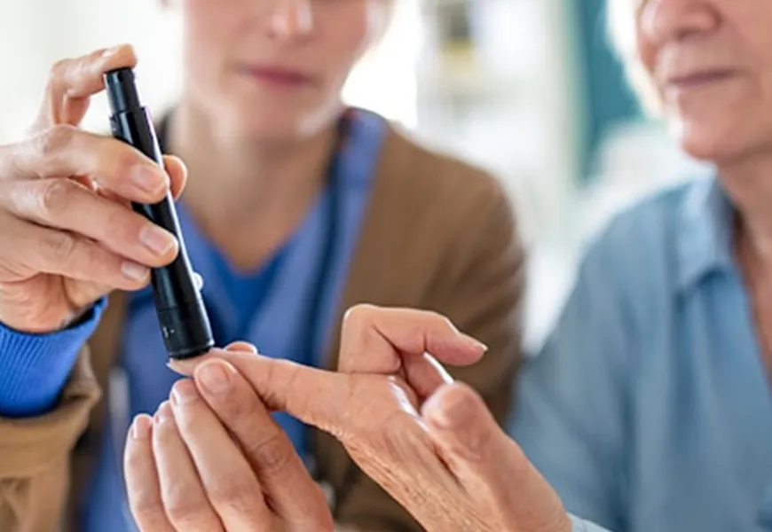 Nurse taking blood sample from a ladies finger
